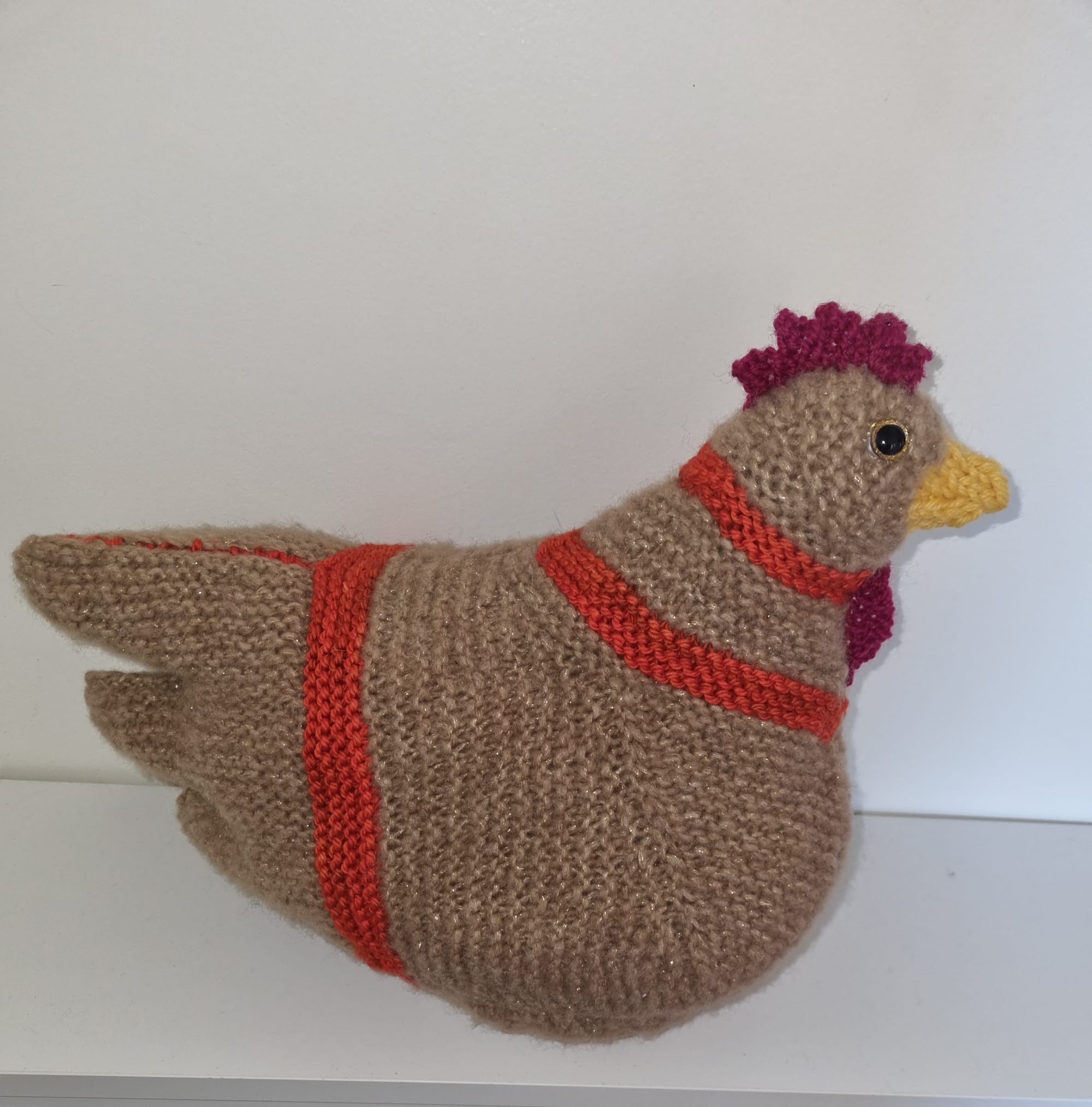 A large, legless, knitted chicken
